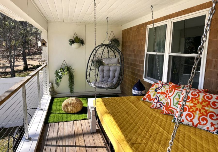 Porch bed swing and egg chair overlooking the water
